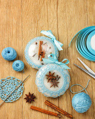 Fototapeta na wymiar White beautiful Christmas balls decorated with a blue knitted pattern on wooden background, top view with wood copy space
