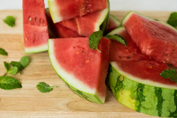 The water-melon cut on pieces, the fresh water-melon strewed listiky mints, healthy nutrition