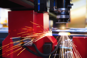 Cutting of sheet metal. Sparks fly from laser by automatic cutting CNC, PLC machine. fabricate...