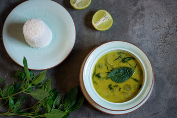 Thai chicken green curry with old wooden background
