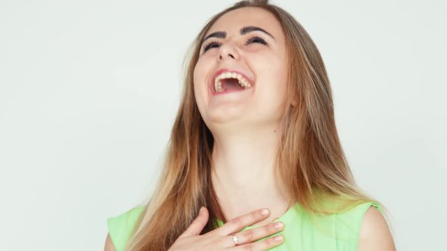 Teenager laughing at camera on white background