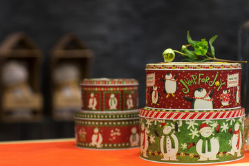 Naklejka na ściany i meble round metal box for the new year painted penguins and snowman