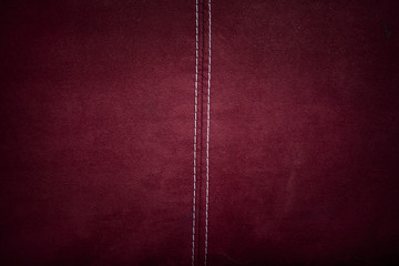 Red alcantara leather background texture with stitching