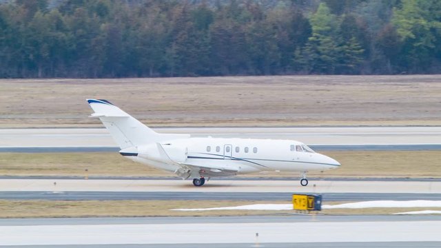 Private White Generic Business Jet Close-up Taxiing at Washington Dulles International Airport IAD in the Winter with No Markings on the Aircraft