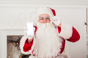 Santa Claus shows a smartphone on white background