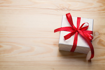 Gift box on wooden table