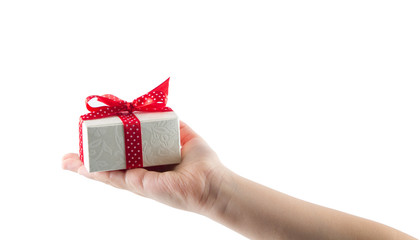 White gift box with red ribbon in hand isolated on white background