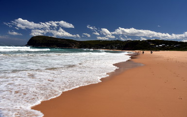 People relaxing on Copacabana Beach on a sunny day (Central Coast, NSW, Australia)