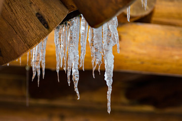 Icicles hanging off log cabin