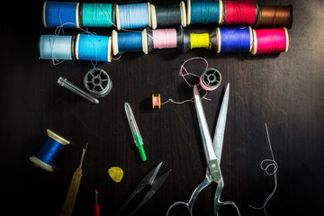 Sewing tools on a wooden table. Sewing tools are what the maid must have.