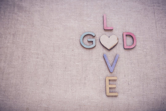 Love God wooden words, toning copy space background
