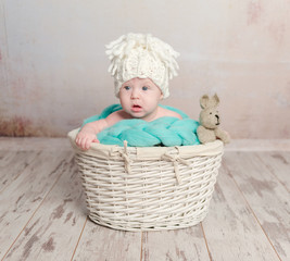 funny little baby sitting in basket