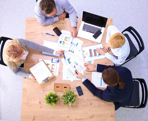 Image of business partners discussing documents and ideas at meeting