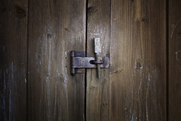 Old weathered wood planks doors with old rusty lock. Texture for background.