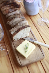 Bread and butter on wooden table