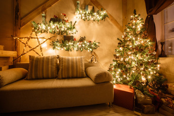 Calm image of interior modern home living room decorated christmas tree and gifts, sofa, table covered with blanket.