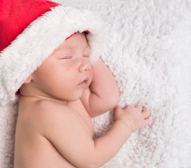 sweet newborn baby in red hat
