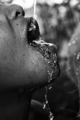 little boy open mouth drinking water
