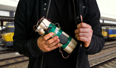 Terrorist in railway station with dynamite bomb in hand