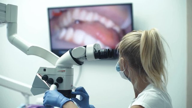 Dental office-specialist tools,intro oral dental camera with live picture of teeth on the monitor.
