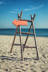 Wooden handmade signpost on the tropic beach.