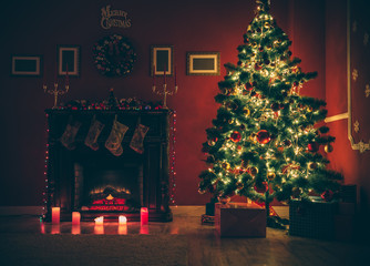 Beautiful Christmas living room with decorated Christmas tree, gifts and fireplace with the glowing lights at night