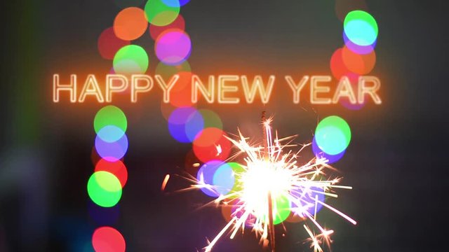 Happy New Year  inscription sparklers on a black background. Colorful lights on the background.