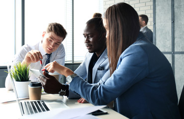 startup business team on meeting in modern bright office interior brainstorming, working on laptop and tablet computer