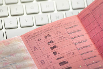 Inside a french driver licence and white keyboard