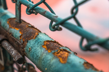 closeup of rusted iron fence locked.