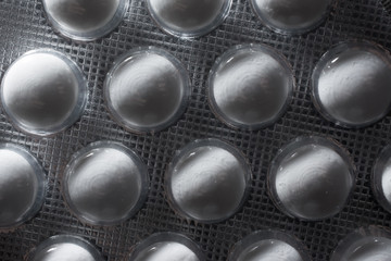 Background in abstract shape, macro photography. Pills packed in