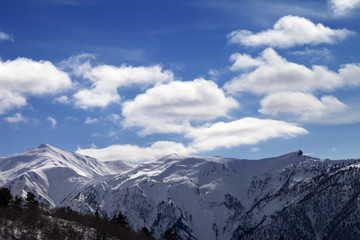 Sunlight snow mountains and blue sky with clouds