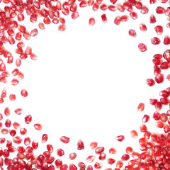 White background with red pomegranate (garnet) seeds