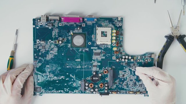 Top view from the first person: the processor. Passive Components PCB micro: resistors and capacitor. Master electrician working with the circuit board. Collection of elements of the PCB with the chip