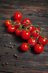 Fresh cherry tomatoes on wood background.