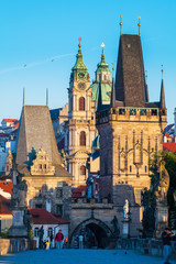 Obraz premium Prague, Czech Republic. Charles Bridge with its statuette at sunrise, Old Town Bridge Tower in the background.