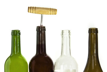Empty wine bottles and one corked on white