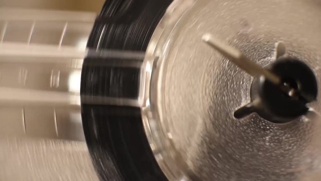 Detail of projector film reel spool running with super 8 filmstrip