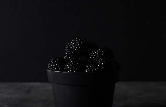 Blackberry. Blackberries  In Black Decorative Vase On A Dark Abstract Background. Copyspace. Healthy Food Concept.  Colorful Festive Still Life. Fresh Berries. Art Food Photography. Dark Light