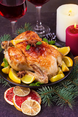 Festive Christmas turkey baked with orange, lemon and lime. Glasses of red wine and candles