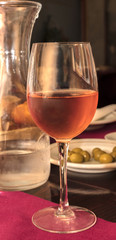 Glass of rose wine in bar, selective focus