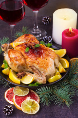 Festive Christmas turkey baked with orange, lemon and lime. Glasses of red wine and candles