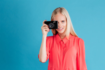 Young pretty girl taking photo using camera