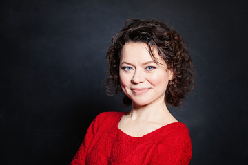 Obraz premium Smiling Mature Woman on Blackboard Background. Mature Beauty