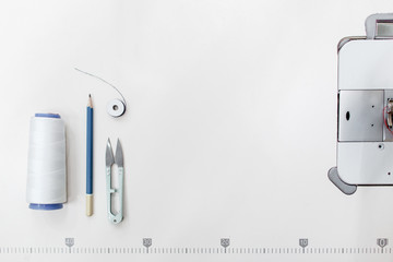 Tailor supplies frame, free space on white background. Top view on sewing machine platform with...