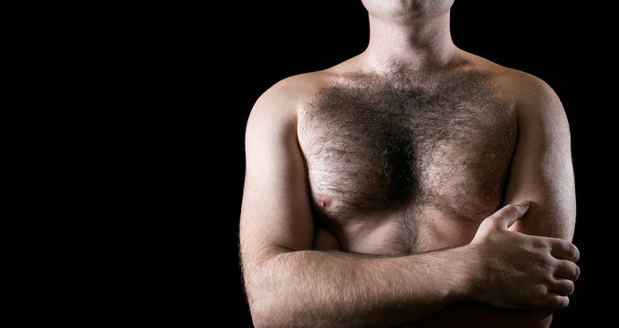 Man with hairy chest isolated on black background for text.