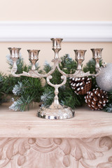 silver candlesticks on a fireplace. Christmas decoration