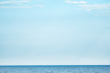 Fototapeta premium Sea and light blue sky. Water with horizon. Embrace the infinity. Journey of thousand miles.
