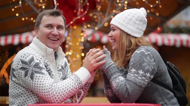 Romantic Couple Smiling on the Christmas Fair, Young Laughing Family Spends Time Together on Winter Holiday. Merry Christmas and Happy New Year