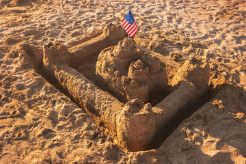 Sandcastle with USA flag. Sand and flag of America. Kingdom of the proud. The strongest fortress.